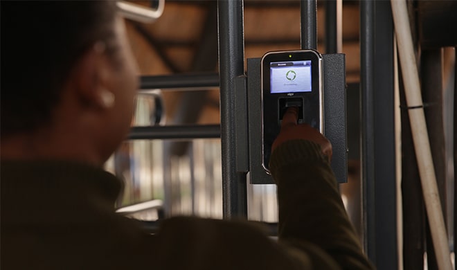 A Man Inputing A Gate Code At A Walk In Gate